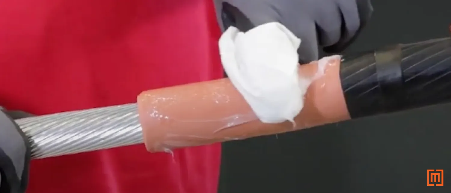Technician spreads silicone along the cables insulation
