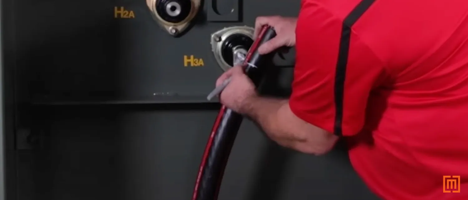 Technician marking cable relative to the bushing