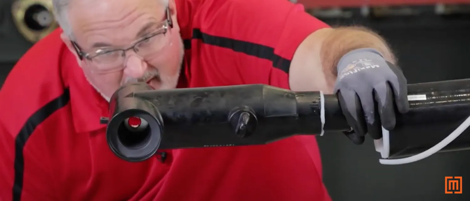 Technician looking through T-Body head