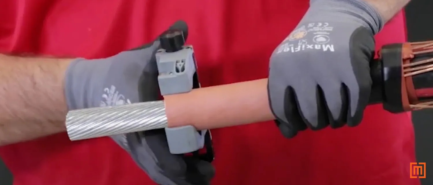 Technician bevels the insulation using a chamfering tool